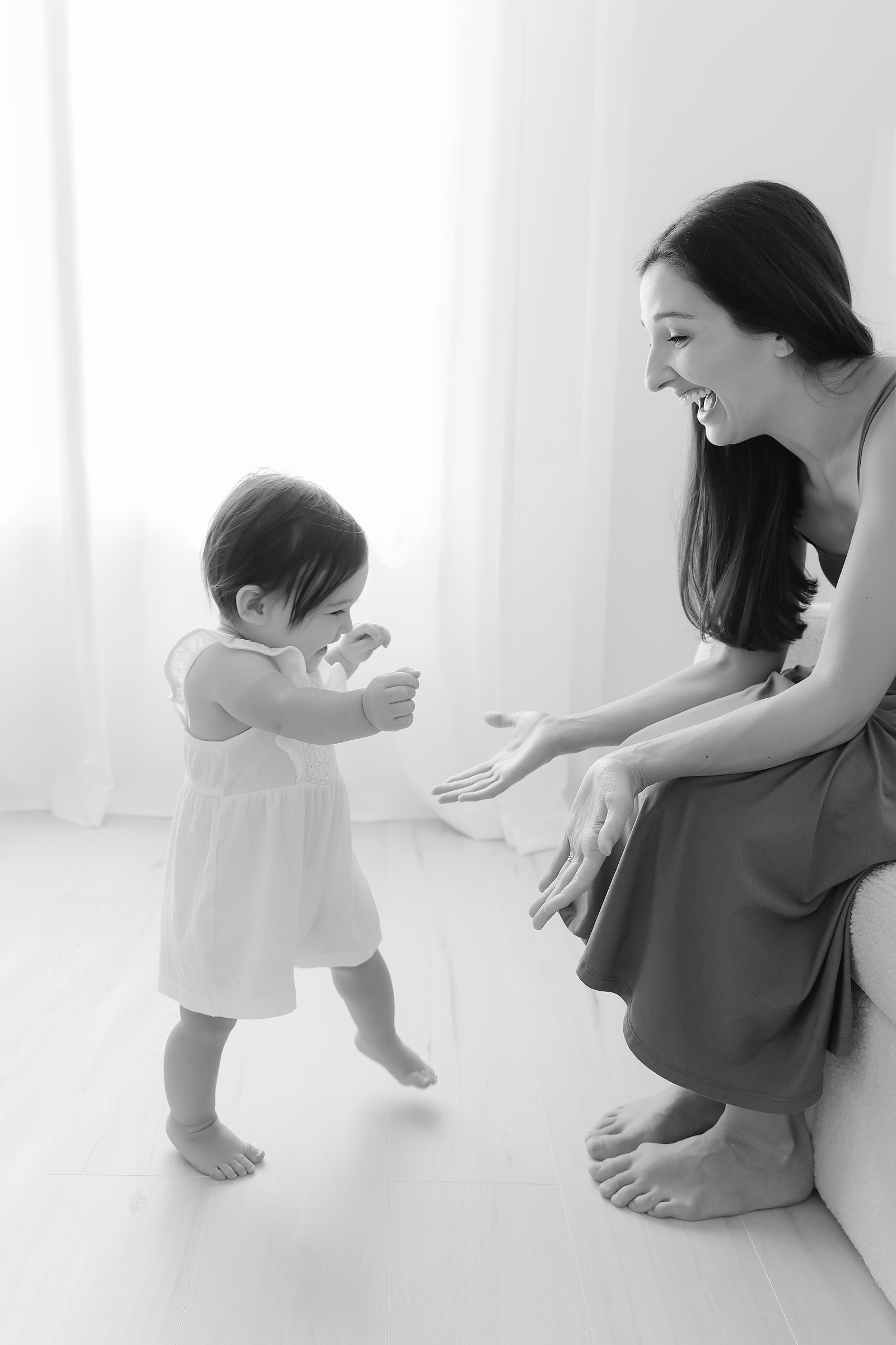 Toddler walks into her mom's outstretched hands